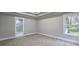 Light-filled bedroom with tray ceiling, neutral carpet, and modern bathroom access at 355 Hilltop Cir Sw Ext, Mableton, GA 30126
