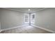 A bedroom featuring carpet, light grey walls, and white trim at 355 Hilltop Cir Sw Ext, Mableton, GA 30126