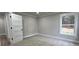 A bedroom featuring carpet, light grey walls, a white framed window and a white door at 355 Hilltop Cir Sw Ext, Mableton, GA 30126