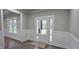 Entryway featuring a white trimmed windows, white wainscoting, wood floors, and a glass paneled front door at 355 Hilltop Cir Sw Ext, Mableton, GA 30126