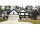Two-story home featuring a brick and white exterior with a two car garage and a charming front porch at 355 Hilltop Cir Sw Ext, Mableton, GA 30126