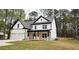 Beautiful two-story home featuring a brick and white exterior with a two car garage and lush lawn at 355 Hilltop Cir Sw Ext, Mableton, GA 30126