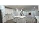 Open layout kitchen with island, staircase, and living room featuring brick fireplace at 355 Hilltop Cir Sw Ext, Mableton, GA 30126