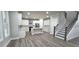 Open-concept kitchen with white cabinets, stainless steel appliances, and adjacent staircase at 355 Hilltop Cir Sw Ext, Mableton, GA 30126