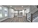 Spacious kitchen boasting white cabinets, a center island, and a staircase leading upstairs at 355 Hilltop Cir Sw Ext, Mableton, GA 30126