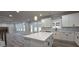Open concept kitchen with white cabinets, an island, and seamless integration to the living room at 355 Hilltop Cir Sw Ext, Mableton, GA 30126