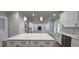 Open kitchen featuring a marble-top island and views of the spacious living area and fireplace at 355 Hilltop Cir Sw Ext, Mableton, GA 30126