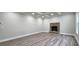 Bright living room featuring a brick fireplace, coffered ceiling, and wood-look flooring at 355 Hilltop Cir Sw Ext, Mableton, GA 30126