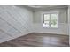 Elegant living room showcasing a decorative wall and natural light from the large window at 355 Hilltop Cir Sw Ext, Mableton, GA 30126