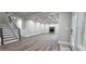 Bright and airy living room featuring stairs, fireplace, and outdoor views from the doorway at 355 Hilltop Cir Sw Ext, Mableton, GA 30126