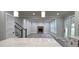 Open layout kitchen with island, staircase, and living room featuring brick fireplace at 355 Hilltop Cir Sw Ext, Mableton, GA 30126