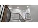 Upstairs hallway and stairway with wood and metal railing at 355 Hilltop Cir Sw Ext, Mableton, GA 30126