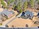 A bird's eye view of a brick house with manicured landscaping and expansive lawn at 3795 Duckcove Way, Cumming, GA 30041