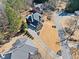 Aerial view of a brick home, illustrating its layout, driveway, and surrounding landscape at 3795 Duckcove Way, Cumming, GA 30041