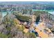 A high-angle view of several homes nestled in a lakeside community with mature trees at 3795 Duckcove Way, Cumming, GA 30041