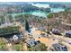 Aerial view of homes nestled in a wooded area near a lake, offering scenic views and a serene setting at 3795 Duckcove Way, Cumming, GA 30041