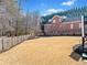 Spacious backyard featuring a well-maintained lawn, wooden fence, and surrounding trees for privacy at 3795 Duckcove Way, Cumming, GA 30041