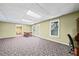 Spacious finished basement with neutral walls, carpet, and walk-out door at 3795 Duckcove Way, Cumming, GA 30041