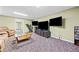 Finished basement featuring carpet flooring, a wet bar, and multiple televisions at 3795 Duckcove Way, Cumming, GA 30041