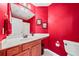 Bright red bathroom with vanity, white counter, and tile flooring at 3795 Duckcove Way, Cumming, GA 30041