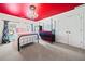 Charming bedroom with a bold red ceiling, chandelier and matching twin beds at 3795 Duckcove Way, Cumming, GA 30041