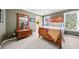 Bedroom features wood furnishings, neutral walls, and view to the outside at 3795 Duckcove Way, Cumming, GA 30041