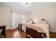 Cozy bedroom with twin beds, hardwood floors, and natural light from a window at 3795 Duckcove Way, Cumming, GA 30041