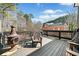 Exterior deck featuring black metal railings, chairs, and a fire pit for outdoor relaxation and entertaining at 3795 Duckcove Way, Cumming, GA 30041
