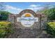 Stone community entrance sign for Adams Landing on Lake Lanier, surrounded by manicured landscaping at 3795 Duckcove Way, Cumming, GA 30041