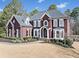 Stately brick residence featuring well-maintained landscaping, black shutters, and a meticulously kept lawn at 3795 Duckcove Way, Cumming, GA 30041