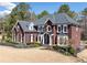 Beautifully landscaped two-story brick home featuring a manicured lawn and architectural details at 3795 Duckcove Way, Cumming, GA 30041