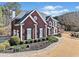Beautiful two-story brick home with black shutters and manicured landscaping at 3795 Duckcove Way, Cumming, GA 30041