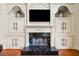 Living room fireplace with marble surround and custom built-ins at 3795 Duckcove Way, Cumming, GA 30041