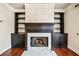 Close-up of a fireplace with built-in shelves, marble hearth, and dark wood trim at 3795 Duckcove Way, Cumming, GA 30041