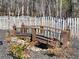 Charming wooden footbridge in a landscaped garden with a decorative fence and lighting at 3795 Duckcove Way, Cumming, GA 30041