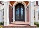 Close-up of a stately front door with white pillars and elegant black hardware at 3795 Duckcove Way, Cumming, GA 30041