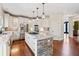 Spacious kitchen featuring a stone island, stainless steel appliances, and hardwood floors at 3795 Duckcove Way, Cumming, GA 30041