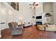 Spacious living room with a fireplace, built-in shelving, and ample seating at 3795 Duckcove Way, Cumming, GA 30041