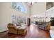 Open-concept living area features large windows, hardwood floors, and comfortable seating at 3795 Duckcove Way, Cumming, GA 30041