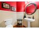 Charming powder room with red walls and an antique vanity at 3795 Duckcove Way, Cumming, GA 30041