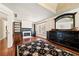 Sitting room features a fireplace, built-in bookshelves, hardwood floors, and a large decorative mirror at 3795 Duckcove Way, Cumming, GA 30041