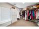 Walk-in closet featuring custom shelves and storage for shoes, folded items and hanging clothes at 3795 Duckcove Way, Cumming, GA 30041