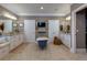A modern bathroom featuring a soaking tub, tiled floor, dual sinks, and a television at 447 Lacy Rd, Canton, GA 30115