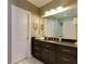 This bathroom features a dark vanity, white marble floors, and ample storage at 447 Lacy Rd, Canton, GA 30115