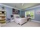 A comfortable bedroom with a ceiling fan, desk, decorative wall art, and a hanging chair at 447 Lacy Rd, Canton, GA 30115