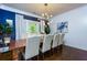 Elegant dining area with wainscoting, chandelier, and a large window providing natural light at 447 Lacy Rd, Canton, GA 30115