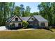 Charming single-Gathering home featuring a well-manicured lawn, a three-car garage, and a timeless design at 447 Lacy Rd, Canton, GA 30115