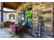Cozy covered front porch with a swing, a brick wall, and a 