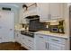 Modern kitchen featuring white cabinets, stainless steel appliances, and stylish backsplash at 447 Lacy Rd, Canton, GA 30115