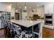 Kitchen with a large island, white cabinets, stainless steel appliances, and unique cowhide print chairs at 447 Lacy Rd, Canton, GA 30115